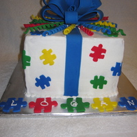 Puzzle Cake This was for a friend's autistic son's birthday. Yellow and chocolate cake with vanilla and chocolate mousse filling, frosted in...