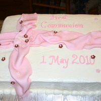 Pink First Communion Italian Cream cake with crusting cream cheese frosting. Fondant ribbon and flowers.