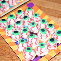 Eyeballs Strawberry cake truffles dipped in white chocolate, royal frosting details.