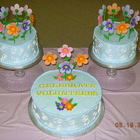 Volunteer Reception Cake WASC w/raspberry filling iced in whipped icing. Flowers are made from fondant/gumpaste mix.