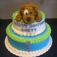 Puppy Birthday Cake Stacked cake covered with buttercream frosting. The puppy is made from cake and fililed in with frosting.