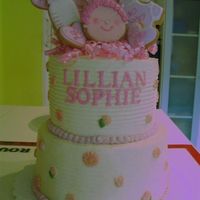 Christening Cake For Lillian top tier is lemon chiffon cake filled with raspberry puree, bottom tier is coconut cake filled with lemon curd. frosted all in lemon-...