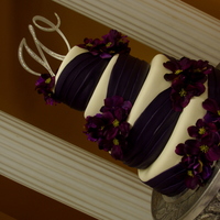 The Lauren fondant wedding cake with purple fondant sash