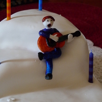 Guitar Guy Birthday cake for our school's choir teacher. Gumpaste guy (only looks slightly, um...off...yea, we'll go with 'off')...
