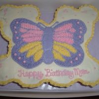 Butterfly Cupcake Cake 1/2 German choc cupcakes w/oreo filling and 1/2 funfetti cupcakes w/vanilla pudding filling. Covered in buttercream w/butterfly.