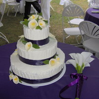 Ginnys Wedding Cake This is a 14,10,6'' chocolate cake with buttercream frosting. I also made the gumpaste calla lilies that are on it as well.