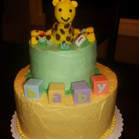 Giraffe Baby Shower Cake Vanilla cake, strawberry filling. Buttercream frosting, Fondant giraffe, bottle and flowers.