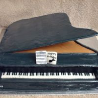 Grand Piano WASC cake covered in BC and fondant. Piano top is cardboard covered in fondant, supported with straws. Keys are a strip of fondant and hand...