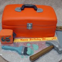 Handyman Birthday Chocolate cake with chocolate raspberry filling covered in BC and fondant. All tools are made out of fondant, tape measure is rice krispy...