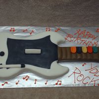 Guitar Hero Birthday WASC cake with vanilla filling, covered in BC and fondant. Pretty easy to do, not much detail in replicating this game!