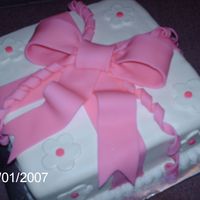 Course 3 Package This is an 8" white cake with amaretto buttercream filling covered with white chocolate rolled fondant. The bow is made of fondant.