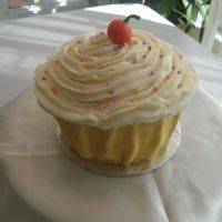 Giant Cupcake 3 6" cakes stacked and carved, BC with fondant "cupcake wrapper" and cherry ...for my goddaughter's first birthday,...