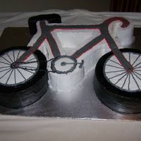 Richard's Bicycle Cake The frame of the bike is yellow cake with the wheels chocolate cake. The cake is iced in buttercream. This cake was requested by my niece...