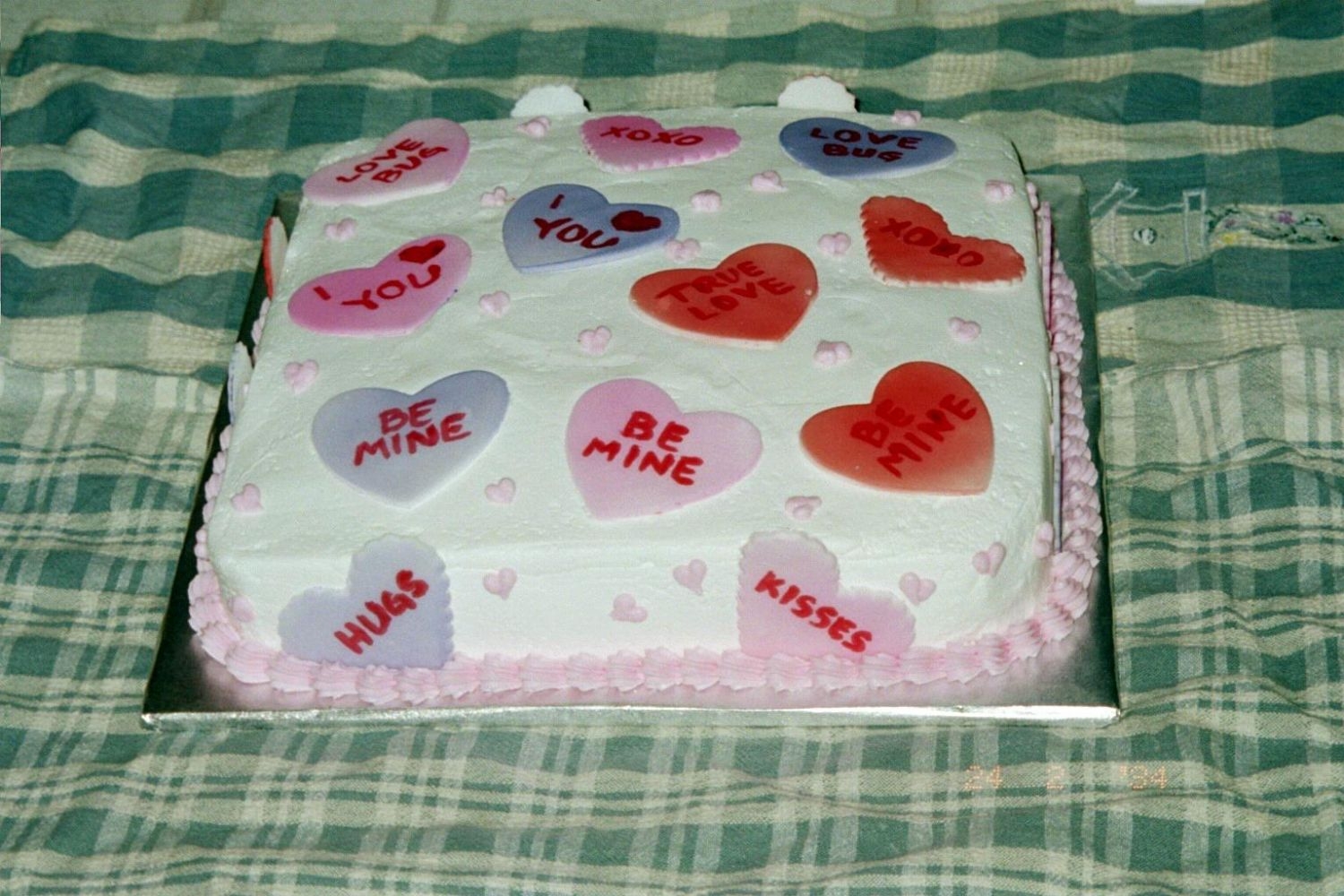 Hearts Cake Just fondant hearts with the message heart sayings written on them. Made it for a bake sale at work.