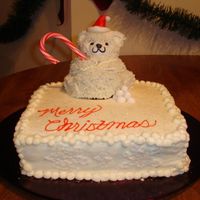 Christmas Bear wilton's mini bear pan. Buttercream with royal icing snowflakes and fondant hatsprinkled with edible glitter