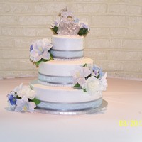 Jen's Wedding Cake Butter Cream Icing, yellow/chocolate cake. Silver/baby blue ribbon with silk flowers.