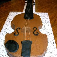 Violin Chocolate cake with creamy chocolate frosting. The black pieces are fondant. The strings are unwaxed, non-mint dental floss.