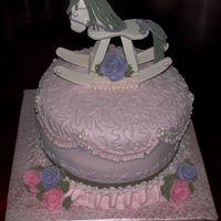 Rocking Horse Baby Shower covered in satin ice, decorated in bc. candy pearls with fondant roses. the rocking horse is gum paste and the main and tail are yarn. i...