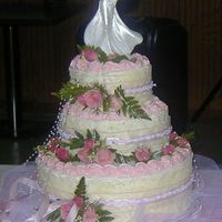 My First Wedding Cake 12, 8, and 6 inch layers. BC icing......decorated with fresh flowers to match the bride's.