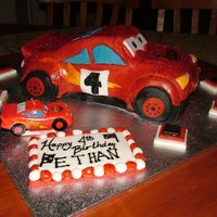 Lighting Mcqueen - Side View Here is the side view of the cake..used the 3D car pan and shaped it. Used wilton's fondant. Red Magic Sparkles..and pearl lustre dust...