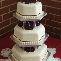 3 Teir Hexagonal 3 teir wedding bottom fruit & top 2 teirs white sponge, covered in ivory icing decorated with brides choice of colour.