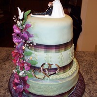 Sage Green Wedding Cake Top is white with raspberry filled...gumpaste flowers, fondant and buttercream...middle chocolate, bottom plain white. Surprise wedding...