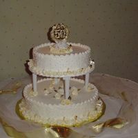 50Th Anniversary Cake I designed this cake by taking ideas off of this website.The roses are royal and tinted gold. The pearls are candy.The client loved it and...
