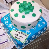 Stacked Presents 10 inch square cake on bottom, 8 inch round on top with buttercream and gumpaste bow.