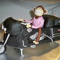 Monkey Riding A Harley This was a crazy cake to make. It is built on a wooden support, cake carved covered in fondant and airbrushed black. The monkey is choc...