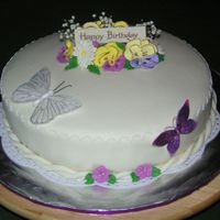 My First Fondant Cake White cake with lemon filling and lemon buttercream icing. Covered with MMF and decorated with RI flowers. Baby's breath was purchased...