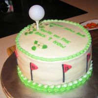 For A Friends 60Th Birthday Chocolate cake with buttercream icing, decorated with Royal Icing and white chocolate flowers. Golf ball is plastic on a wooden tee.