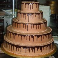 Chocolate Overload! This cake is chocolate inside and out :D Mousse filling, chocolate fudge cake, chocolate buttercream, and chocolate ganache. The bride was...