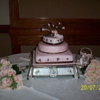 My First Wedding Cake This is my first wedding cake i did for a friend,she designed the cake herself,her colours were chocolate and pink.The bottom was square...