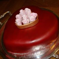 Heart Of Gold Chocolate cake covered in fondant. Airbrushed red. Fondant flowers and gold heart