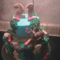 Hunting Buttercream with fondant shot gun shells, and toy deer.