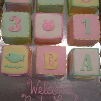 Blocks This is a Baby Block cake from the Martha Stewart website. Cakes are about 4 x 4 covered in MMF with RI and MMF decorations.