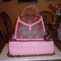 Nolita's Purse This was for our pastor's wife. The "logo" is her initial. The base is doule stacked 9x13 white cake w/ strawberry filling/...