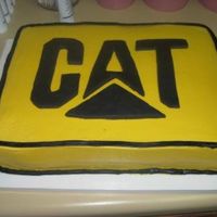 Cat Emblem Groom's cake done in yellow cake w/ buttercream icing. Emblem cut from fondant and placed on cake. Tha emblem was drawn and cut by the...
