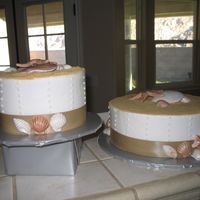 Beach Wedding Cake shells were made with fondant and shimmer dust, sand was graham cracker crumbs. thanks for looking