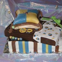 Gift Box/pillow Cake pillow was made by friend she did a great job, the box is a three layer cake with the top cake turned used fondant for the onsie, pillow...