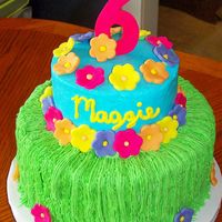 Maggie's Luau This is a 10 in chocolate and 6 inch white cake. Iced in buttercream with fondant flowers. Thanks to lynsey for the grass skirt idea. It...