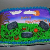 Graveyard White 1/4 sheet cake with buttercream frosting. Tombstones are sugar candy ones also candy pumpkins