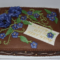 50Th Bd Cake Choc cake with PB mousse filling and choc bc. Flowers are fondant/gp.