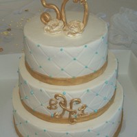 50Th Annviersay white cake,bc icing, gold fondant ribbon, gumpaste letters and numbers, pearl blue dragrees