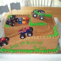 Monster Truck Dirt Track chocolate cake,bc frosting, toy monster trucks