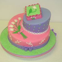Topsy Turvy! The cake is a Topsy Turvy cake covered with fondant and the tulips and details on the side are made out of gumpaste.