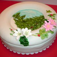 Christmas Day The cake was covered with fondant and the trees were painted with food coloring, and on top of the cake there is a cake ring covered with...