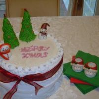 Xmas Cake Fruit cake iced with royal icing. Fondant snow man and RI trees..
