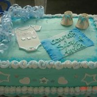 Baby Shower Cake Wihite almond sour cream cake with raspberry choclate mousse and pineapple nu whipped cream filling..with buutercream frosting. cake is 11X...