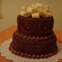 Chocolate Cake With Ganache Frosting , Filling And Scroll. Fondant Bows My first cake after my wilton class..Would welcome all constructive criticisms.